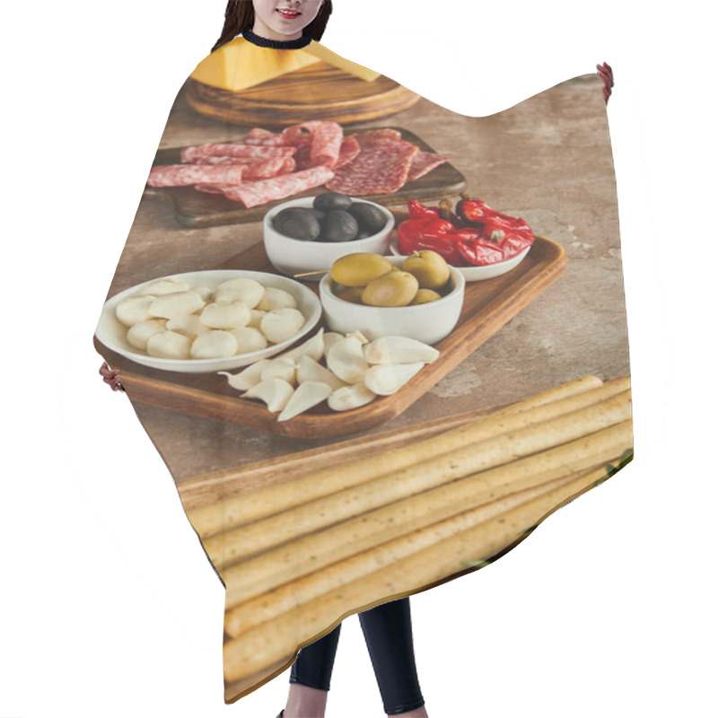 Personality  High Angle View Of Boards With Breadsticks, Salami, Rosemary, Cheese And Bowls With Antipasto Ingredients On Brown Hair Cutting Cape