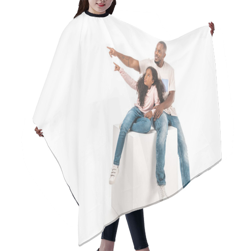 Personality  Smiling African American Father And Daughter Looking Away And Pointing With Finger While Sitting On Cube Together On White Background Hair Cutting Cape