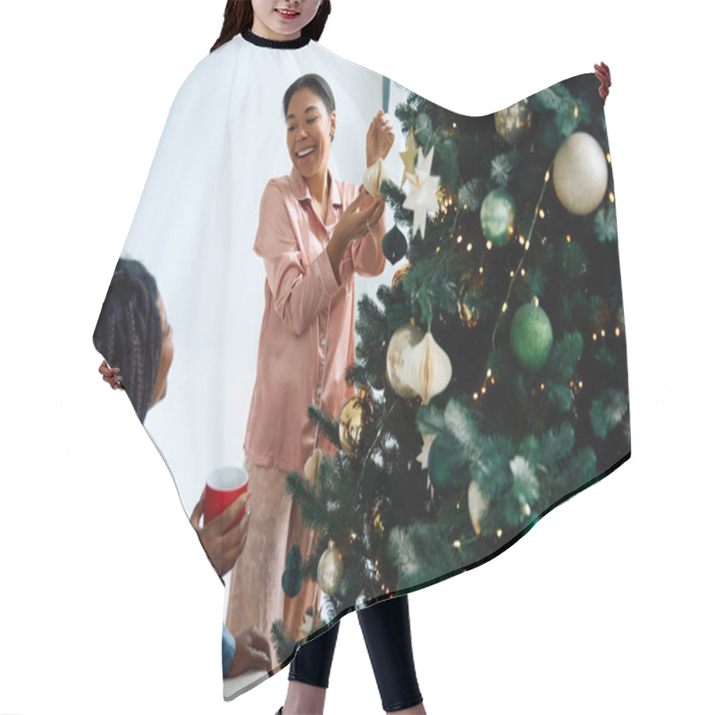 Personality  Two Women Share Laughter While Decorating A Christmas Tree, Creating A Warm Festive Atmosphere. Hair Cutting Cape