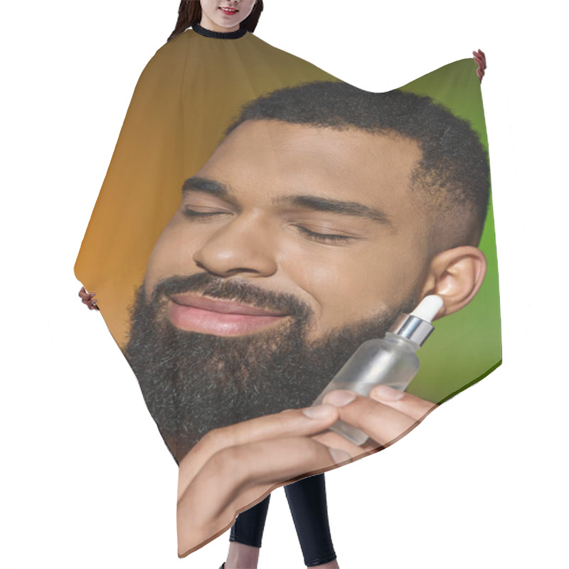 Personality  African American Handsome Man Holds Serum. Hair Cutting Cape