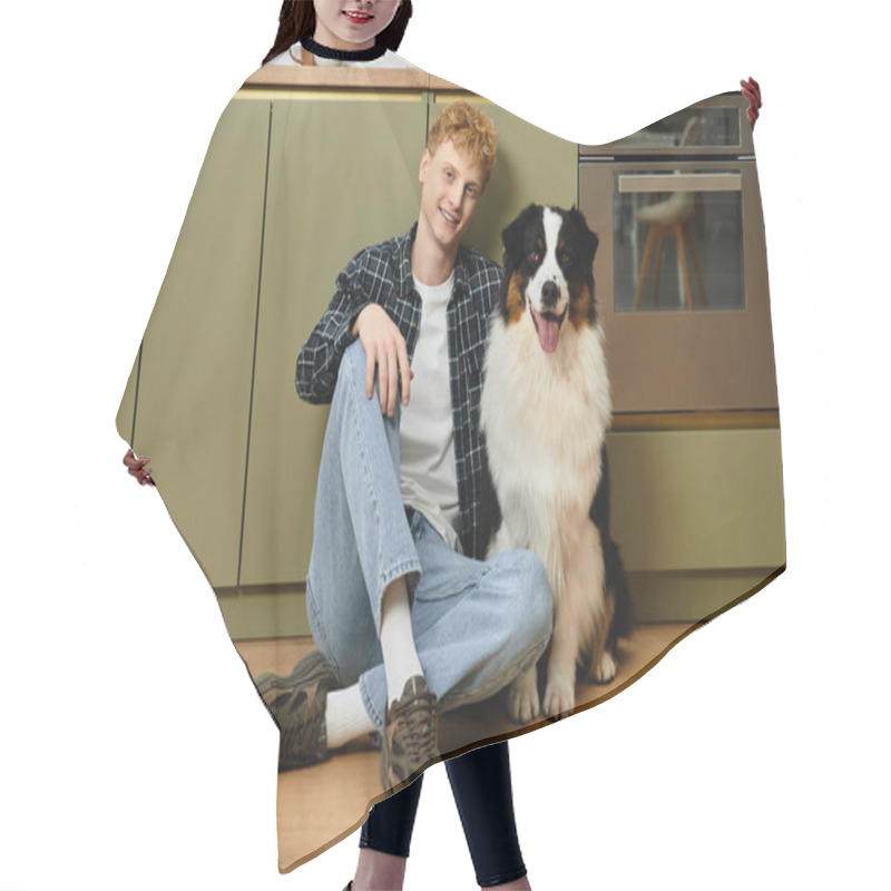 Personality  A Young Man With Red Hair Sits On The Floor Beside His Furry Australian Shepherd In A Stylish Home. Hair Cutting Cape