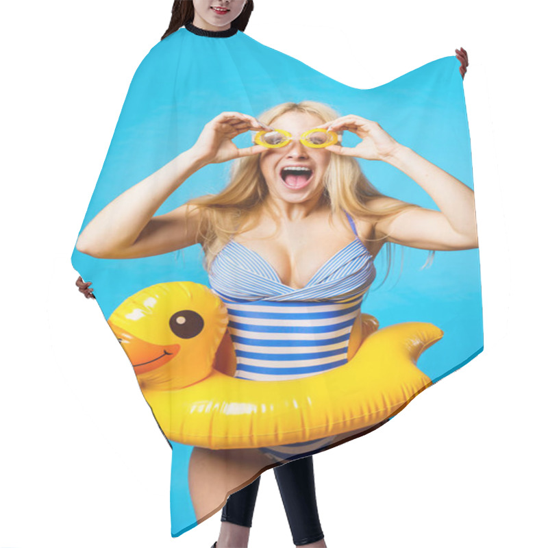 Personality  Image Of Screaming Blonde In Striped Swimsuit, Swimming Goggles With Lifebuoy Duckling At Waist On Empty Blue Background Hair Cutting Cape