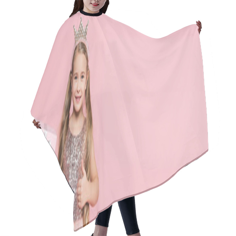 Personality  Joyful Little Girl In Crown Holding Wrapped Present And Showing Thumb Up Isolated On Pink, Banner Hair Cutting Cape