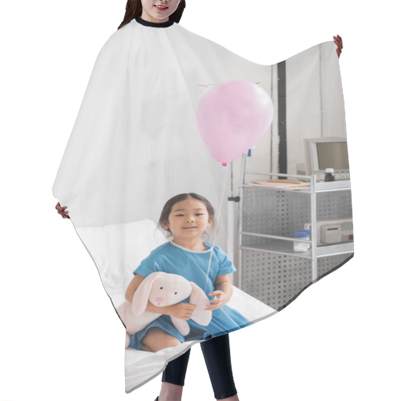 Personality  Carefree Asian Girl Smiling At Camera While Sitting With Balloon And Toy Bunny On Hospital Bed Hair Cutting Cape