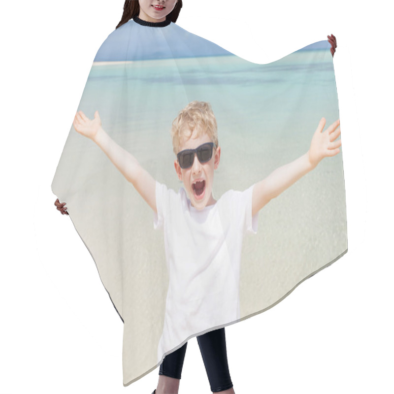 Personality  kid at the beach hair cutting cape