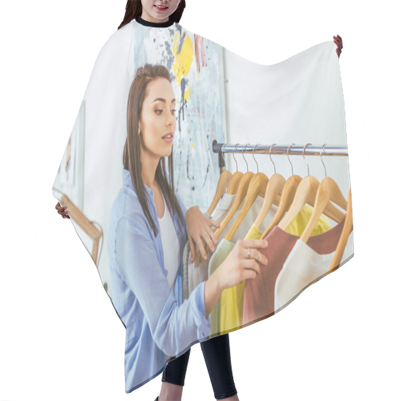 Personality  Beautiful Designer Looking At Clothes On Hangers   Hair Cutting Cape