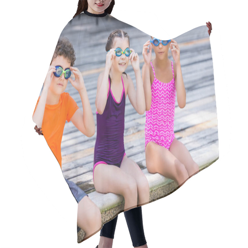 Personality  Girls In Swimsuits And Boy In T-shirt Touching Swim Goggles While Sitting On Pool Deck Hair Cutting Cape