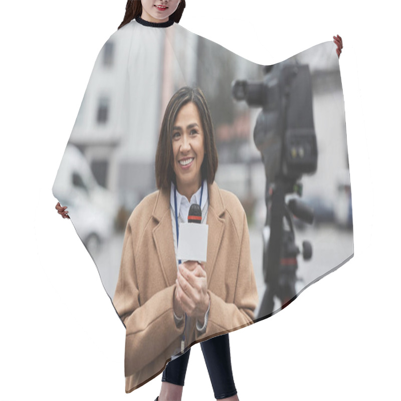 Personality  A Multiracial Female Journalist In A Beige Coat Reports Live Outdoors, Sharing Vital News Through Her Microphone. Hair Cutting Cape