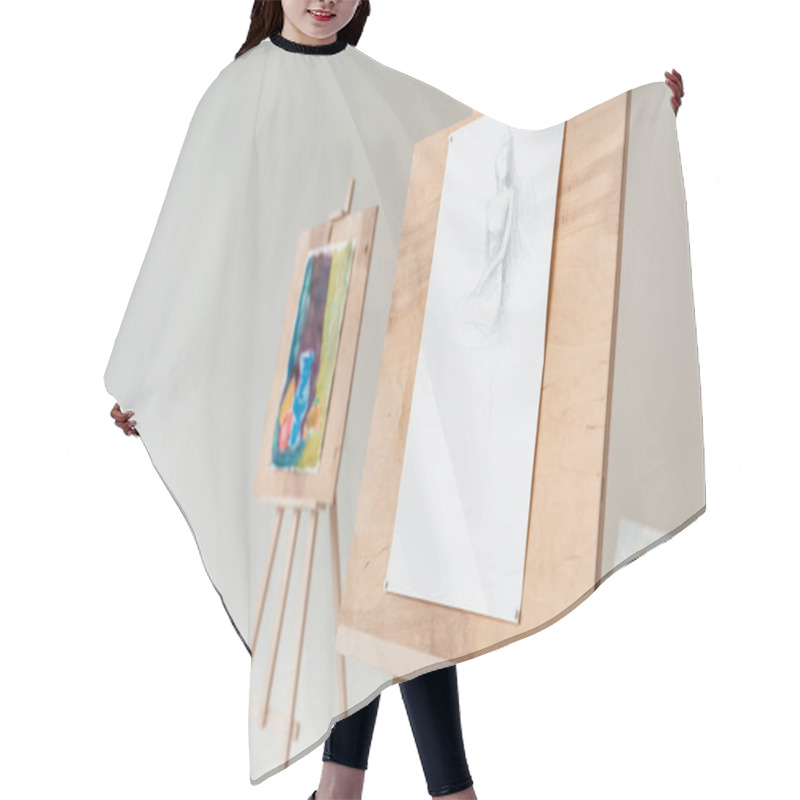 Personality  Easels With Artistic Paintings In Empty Art Studio On Grey Hair Cutting Cape