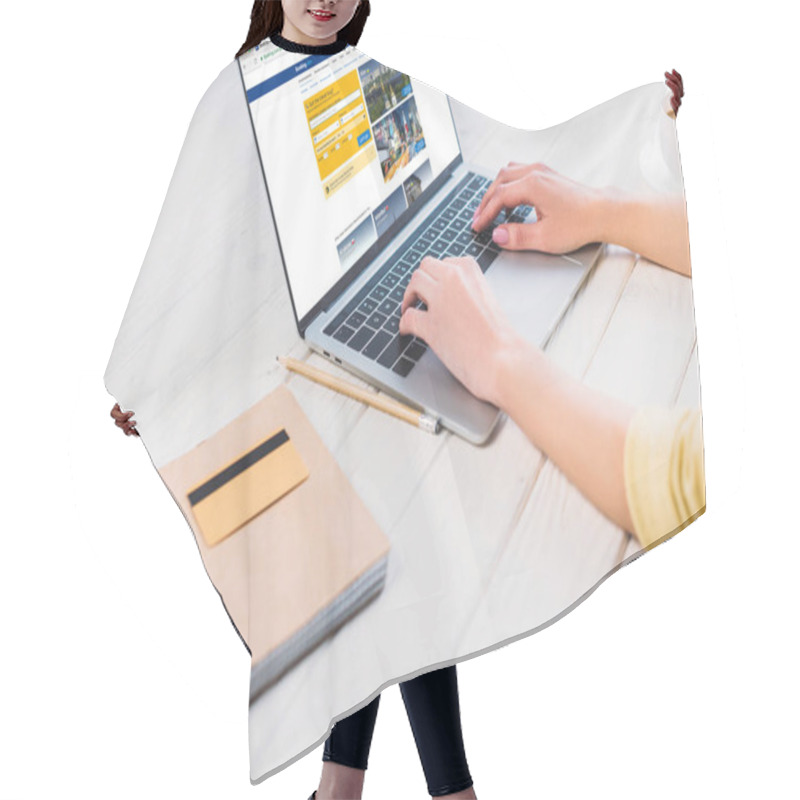 Personality  Cropped View Of Woman Using Laptop With Booking Website On Screen  Hair Cutting Cape