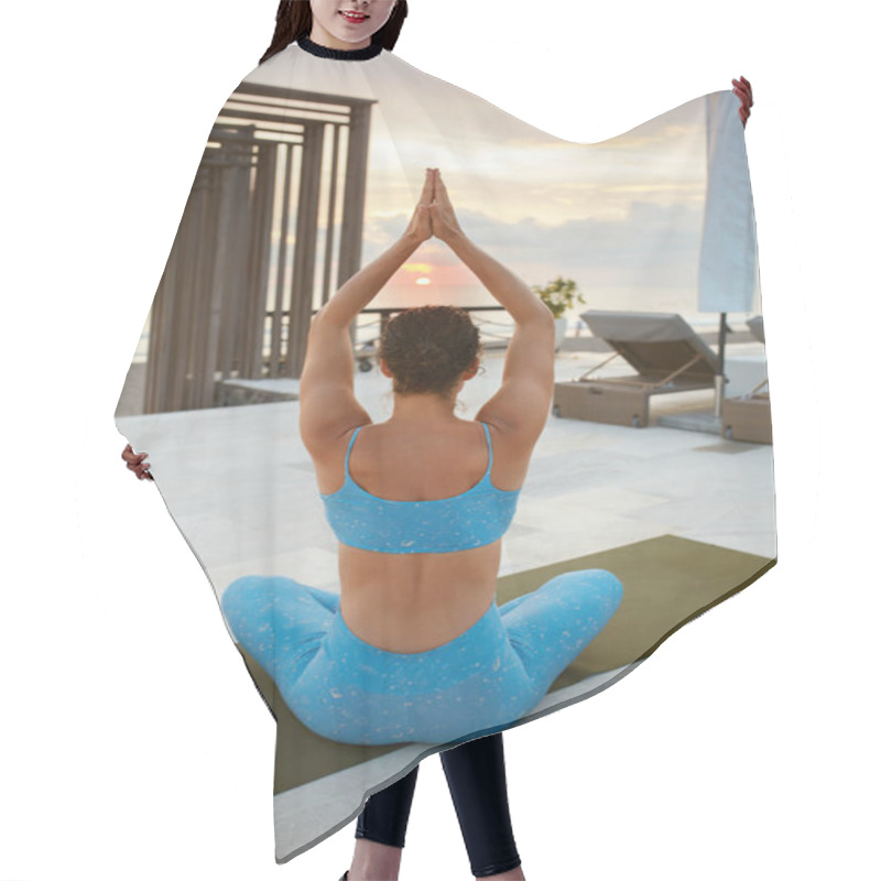 Personality  Yoga. Woman Sitting In Easy Pose. Brunette In Blue Sportswear Doing Sukhasana Keeping Hands Above Head. Female Meditating And Looking On Sunset. Yoga Exercising As Lifestyle. Hair Cutting Cape