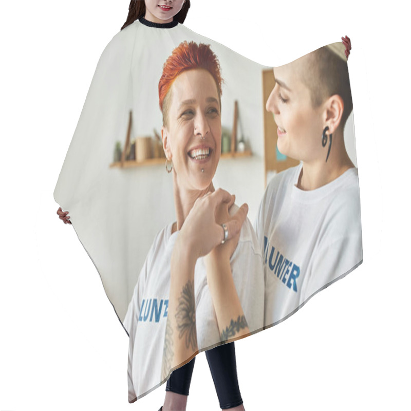 Personality  A Young Lesbian Couple In Volunteer T-shirts Doing Charity Work, Standing Next To Each Other. Hair Cutting Cape