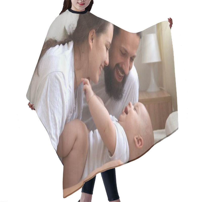 Personality  Woman And Man Holding Newborn. Mom, Dad And Baby On Bed. Close-up. Portrait Of Young Smiling Family With Newborn On Hands. Happy Marriage Couple On Background. Childhood, Parenthood, Infants Concept Hair Cutting Cape