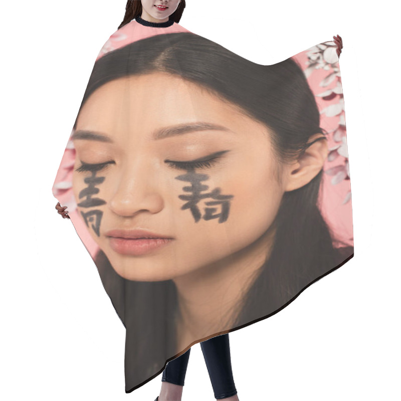 Personality  Asian Woman With Closed Eyes And Hieroglyphs On Face Isolated On Pink  Hair Cutting Cape