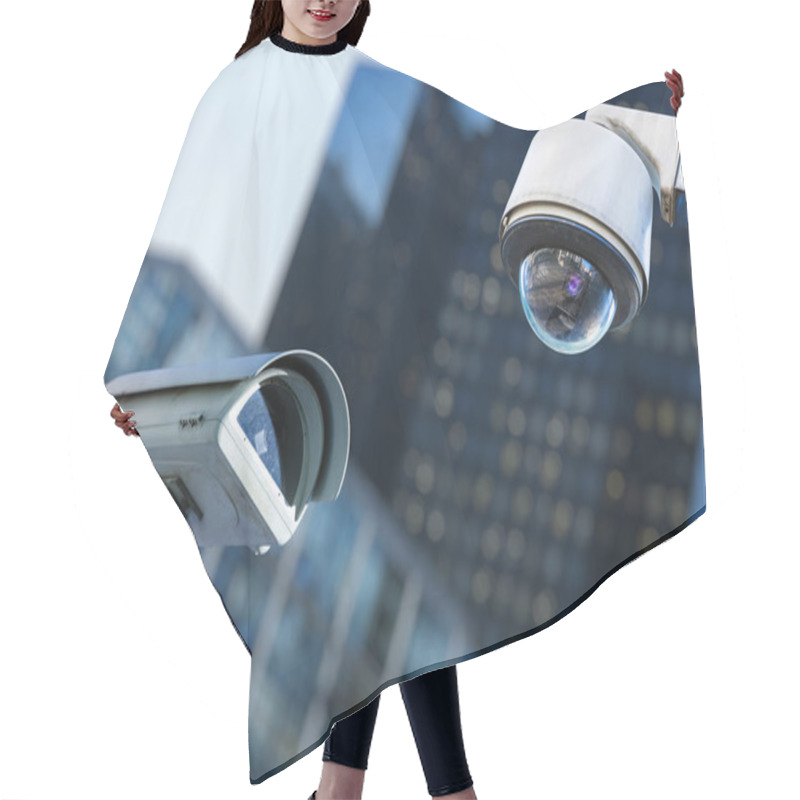 Personality  Two Cctv Security Camera In A City With Blury Business Building On Background Hair Cutting Cape