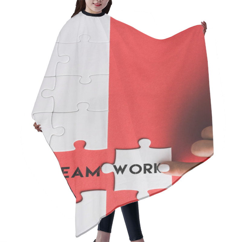 Personality  Top View Of Woman Pointing With Finger At Jigsaw Near Connected Puzzle Pieces With Teamwork Lettering On Red Hair Cutting Cape