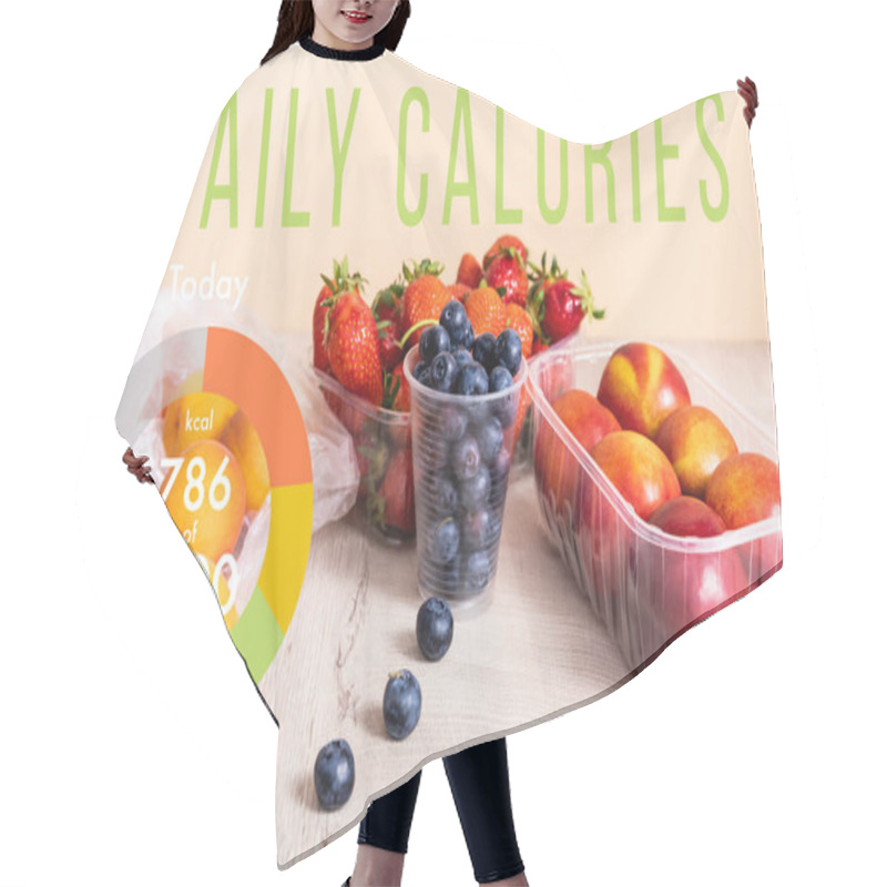 Personality  Blueberries, Strawberries, Nectarines And Peaches In Plastic Containers On Wooden Surface Near Daily Calories Lettering On Beige Hair Cutting Cape