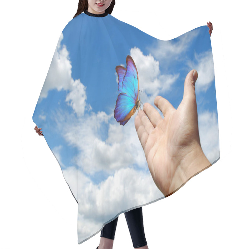 Personality  Butterfly Morpho Sitting On The Hand. Hand Raised To The Sky. Butterfly On The Hand On A Sky Background. Peaceful Sky Hair Cutting Cape