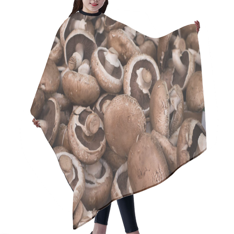 Personality  Fresh Champignon Mushrooms On The Market. Top View. Close-up Hair Cutting Cape