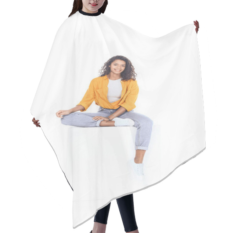 Personality  Teenage African American Student Girl Sitting On White Cube And Looking At Camera Isolated On White Hair Cutting Cape