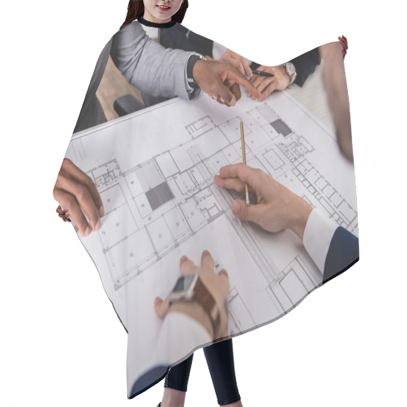 Personality  Partial View Of African American Businessman Pointing With Finger At Blueprint Near Multicultural Partners, Blurred Foreground Hair Cutting Cape