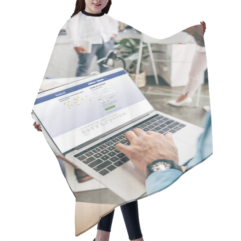 Personality  Cropped Shot Of Young Businessman Using Laptop With Facebook Website On Screen  Hair Cutting Cape