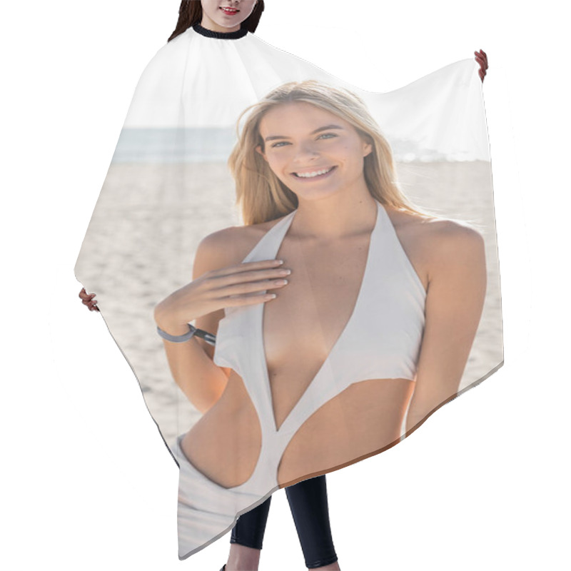 Personality  A Young And Beautiful Blonde Woman Poses Gracefully In A White Swimsuit On The Sandy Shores Of Miami Beach. Hair Cutting Cape