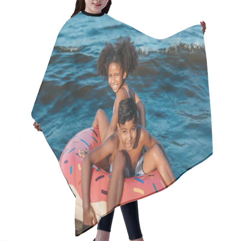 Personality  African American Siblings On Swimming Tube  Hair Cutting Cape