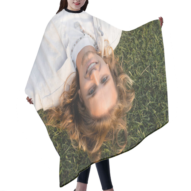 Personality  Top View Of Young And Happy Man With Long Fair Hair Looking At Camera While Relaxing On Grassy Lawn Hair Cutting Cape