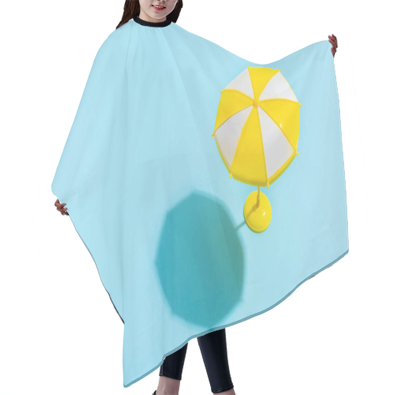 Personality  Summer Concept. Sun Umbrella With Sun Shadow On Blue Background. Sun Protection Concept In Summer. Hair Cutting Cape