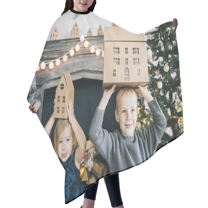 Personality  Children - A Boy And A Girl Are Sitting By The Fireplace, A New Year Tree, Playing With Cardboard Houses, A Cozy Christmas Decor And Children's Emotions Hair Cutting Cape