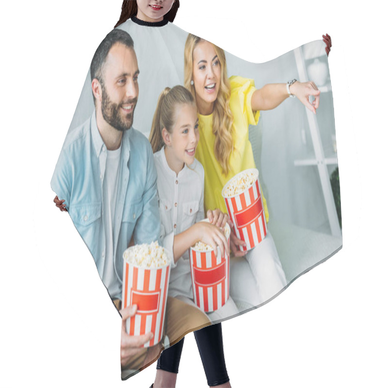 Personality  Smiling Young Family Watching Movie At Home With Buckets Of Popcorn And Pointing At Tv Hair Cutting Cape