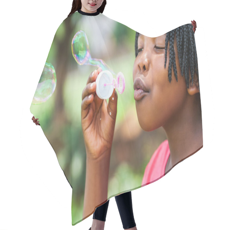 Personality  African Girl With Braids Blowing Bubbles. Hair Cutting Cape