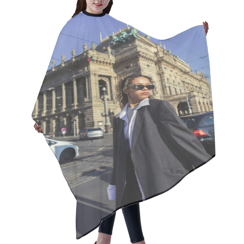 Personality  Curly African American Woman In Oversized Blazer And Sunglasses Standing Near National Theatre In Prague Hair Cutting Cape