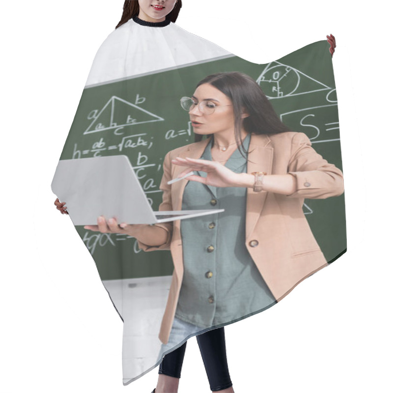 Personality  Teacher Holding Chalk And Laptop During Online Lecture Near Chalkboard In Classroom  Hair Cutting Cape