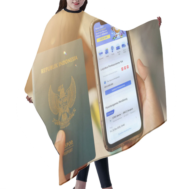 Personality  Cropped Hand Of Woman Shopping Online For Flight Tickets On Airline Website With Smartphone.tiket.com Mobile Application. Hair Cutting Cape