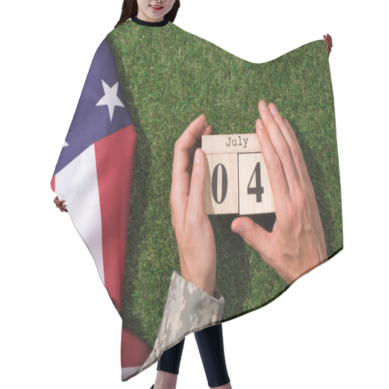 Personality  Cropped Shot Of Soldier In Military Uniform Holding Calendar With 4th July Date With American Flag On Green Grass, Americas Independence Day Concept Hair Cutting Cape