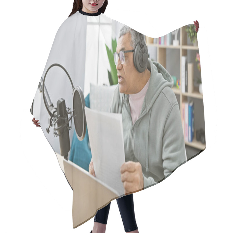 Personality  Middle-aged man with headphones reading a script indoors at a podcasting studio setup. hair cutting cape