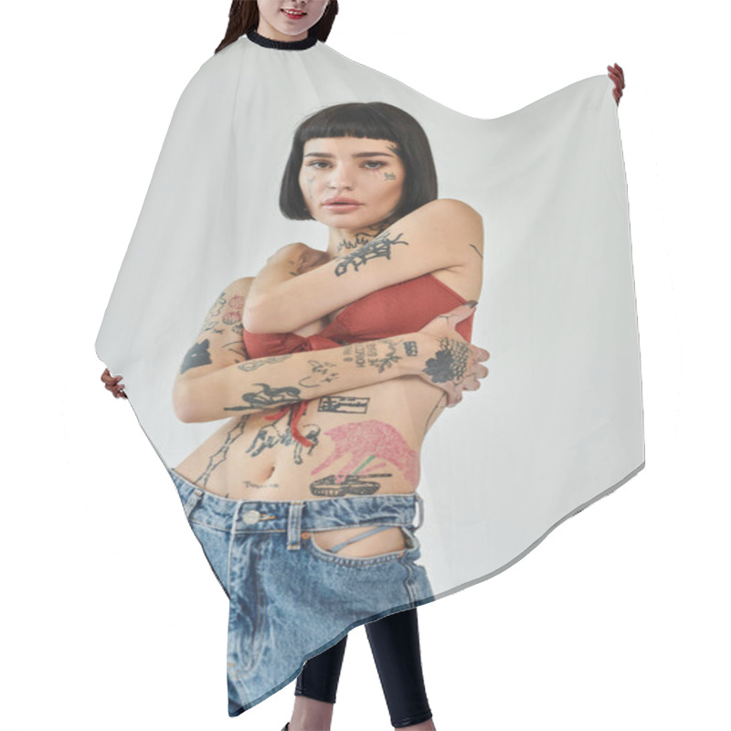 Personality  A Confident Woman Poses Fashionably, Showcasing Her Tattoos And Trendy Outfit. Hair Cutting Cape