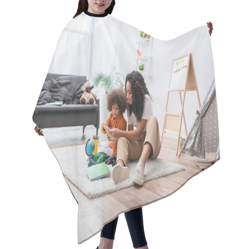 Personality  Young Woman Holding Notebook Near Daughter, Backpack And Globe At Home  Hair Cutting Cape