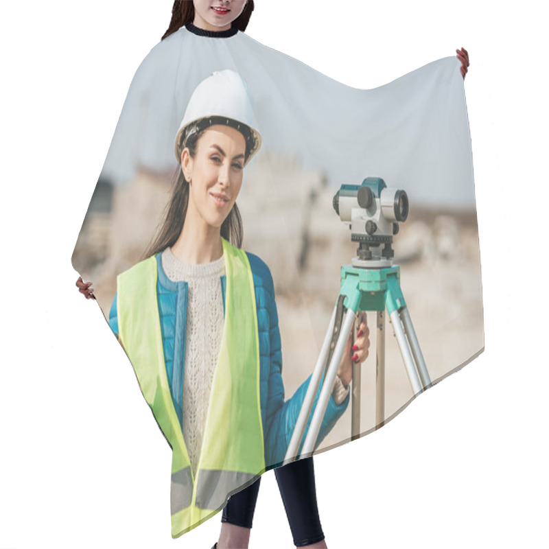 Personality  Attractive Surveyor With Digital Level And Radio Set Smiling At Camera Hair Cutting Cape