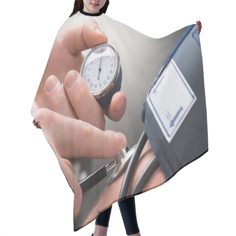 Personality  Close-up Of A Doctor's Hand Checking Blood Pressure Of A Patient Hair Cutting Cape