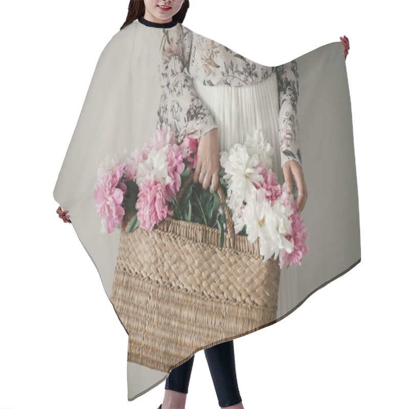 Personality  Boho Girl Holding Pink And White Peonies In Rustic Basket. Stylish Hipster Woman In Bohemian Floral Dress Gathering Peony Flowers. Happy Mothers Day. International Womens Day. Hair Cutting Cape