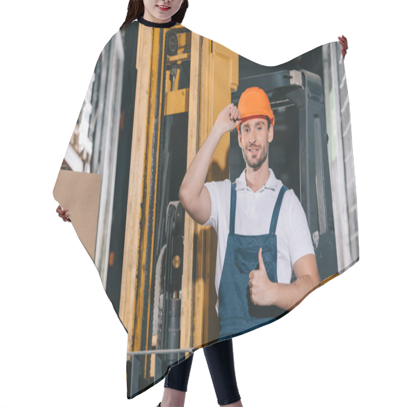 Personality  Smiling Warehouse Worker Touching Helmet And Showing Thumb Up While Standing Near Forklift Loader Hair Cutting Cape