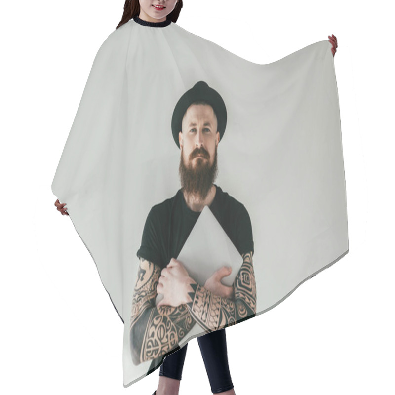 Personality  Handsome Bearded Tattooed Man Hugging Laptop And Looking At Camera On White Hair Cutting Cape