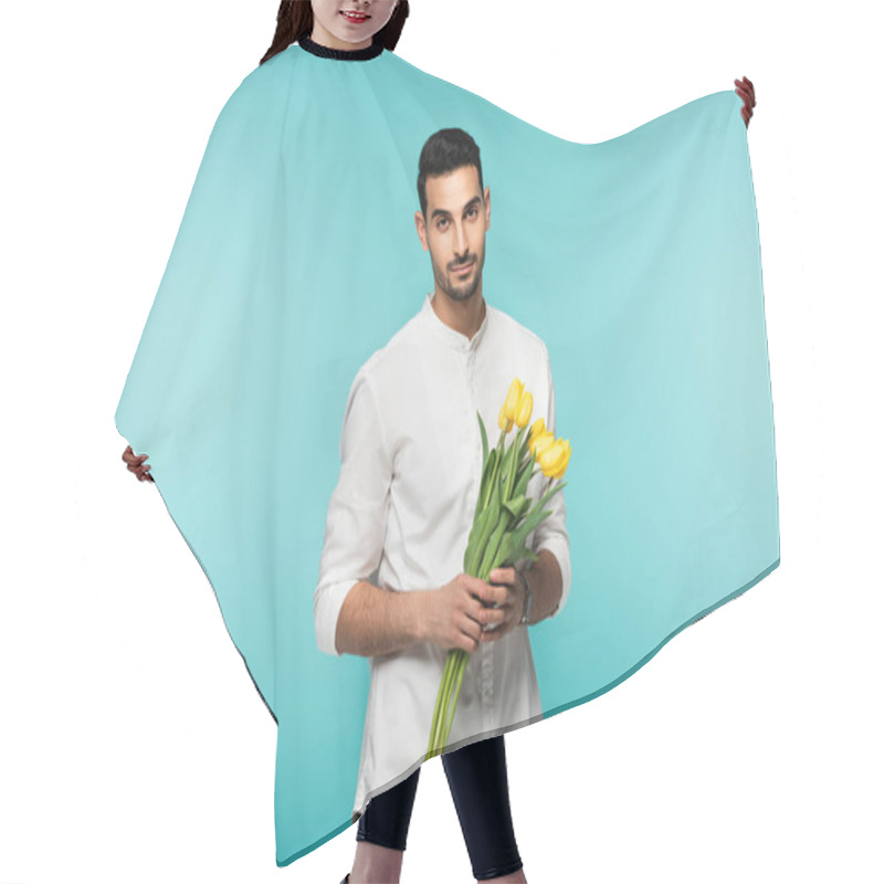 Personality  Arabian Man With Yellow Tulips Looking At Camera Isolated On Blue  Hair Cutting Cape