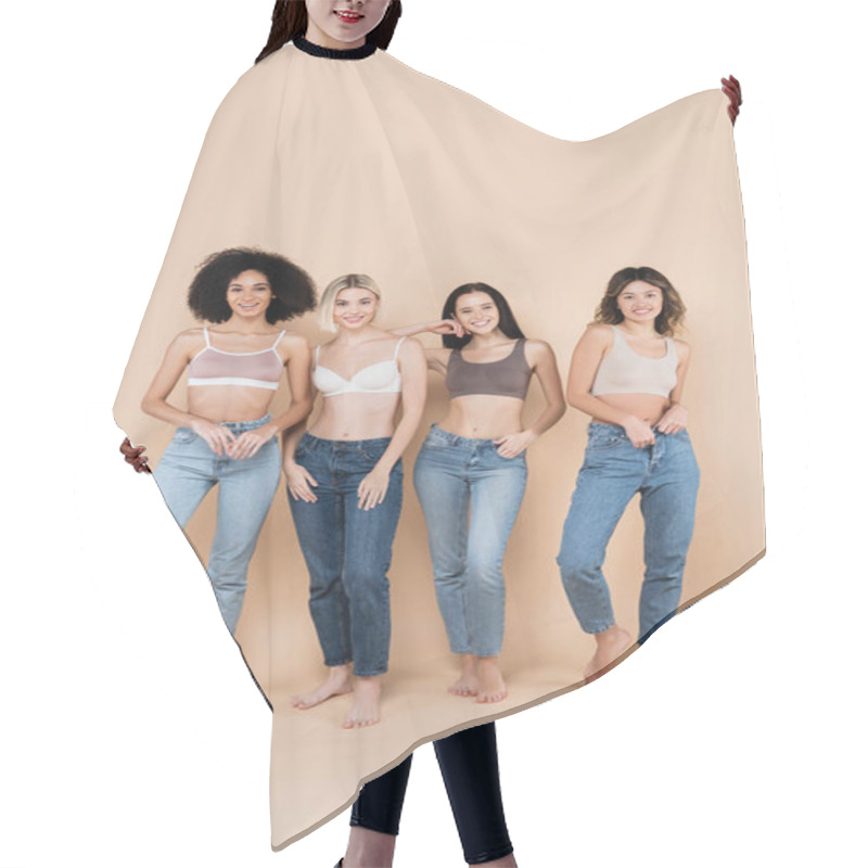 Personality  Full Length View Of Young Multiethnic Women In Bras And Jeans Posing On Beige Hair Cutting Cape