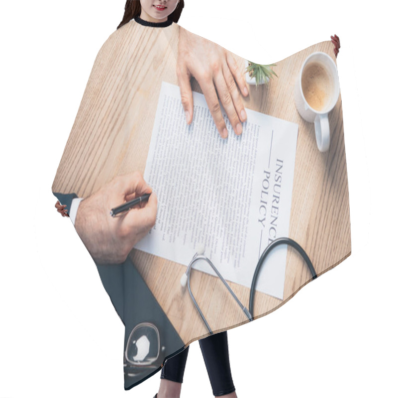 Personality  Cropped View Of Lawyer Signing Insurance Policy Agreement Near Plant, Glasses, Notebook And Stethoscope On Desk Hair Cutting Cape