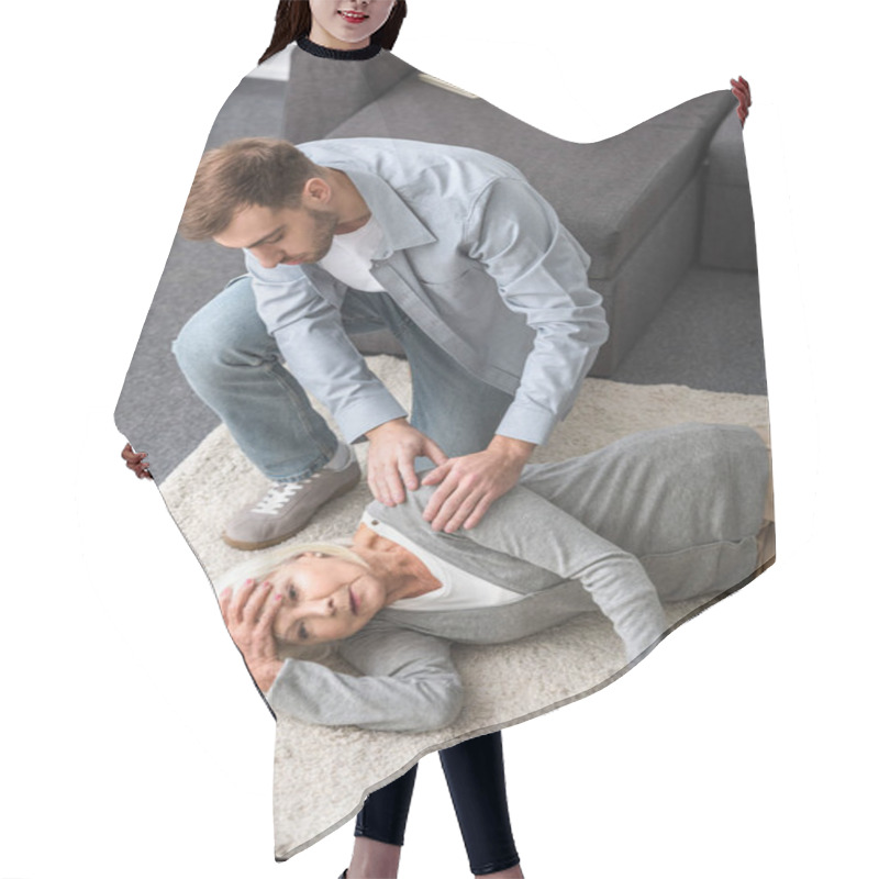 Personality  Overhead View Of Adult Man With Sick Senior Mother Lying On Carpet Hair Cutting Cape