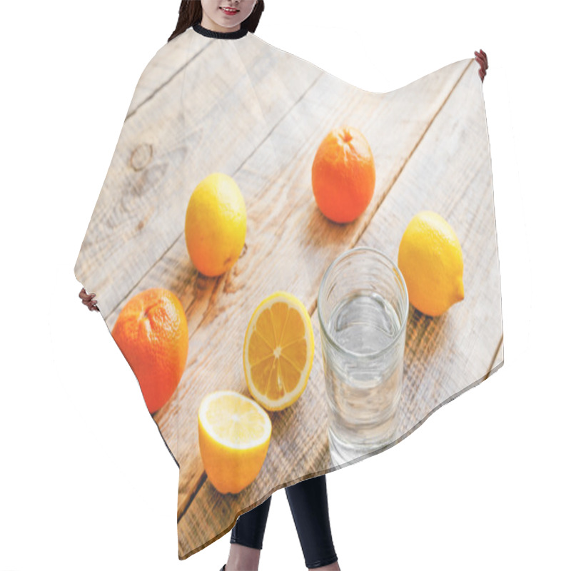 Personality  Composition Of Lemons, Oranges And Glass With Water  Wooden Table Hair Cutting Cape